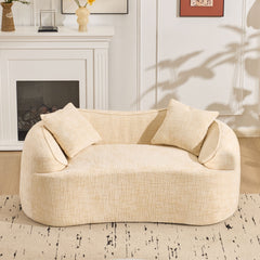 Beige curved two - person compress sofa. It has armrests on both sides, comes with two pillows, is suitable for small - sized apartments, and can be placed in the living room or bedroom.