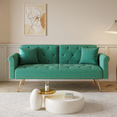 A 69.7-inch-long sofa bed covered in green velvet fabric, featuring nail head trim and accompanied by a matching throw pillow