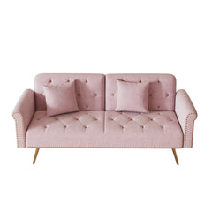 A 69.7-inch-long sofa bed covered in pink velvet fabric, featuring nail head trim and accompanied by a matching throw pillow