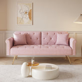 A 69.7-inch-long sofa bed covered in pink velvet fabric, featuring nail head trim and accompanied by a matching throw pillow
