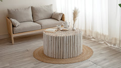 T1009 handcrafted round coffee table made from natural wooden logs featuring a detailed carved top, earthy charm in White