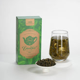 Tea packaging with a glass of tea and a bowl of tea leaves on a white background