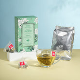 Tea packaging and cup on a light blue background