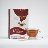 Box of black tea with a cup of tea on a white background