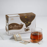 Qing Brick Tea packaging with a glass of tea on a white background