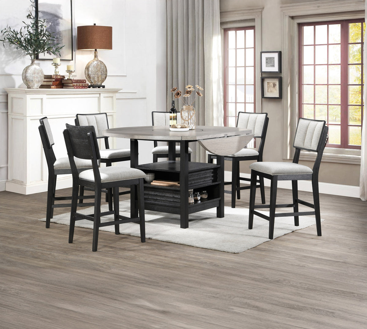 7pc Farmhouse Contemporary Counter Height Dining Set Storage Table Single Pedestal Round Black Gray Natural Grain Integrated Turntable Drop Leaves Built-in Shelving Fabric Upholstery Chairs