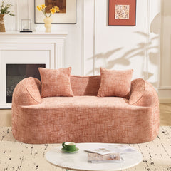 Pink curved two - person compress sofa. It has armrests on both sides, comes with two pillows, is suitable for small - sized apartments, and can be placed in the living room or bedroom.