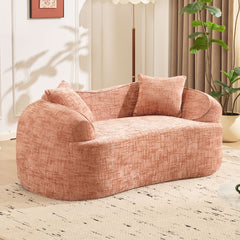 Pink curved two - person compress sofa. It has armrests on both sides, comes with two pillows, is suitable for small - sized apartments, and can be placed in the living room or bedroom.