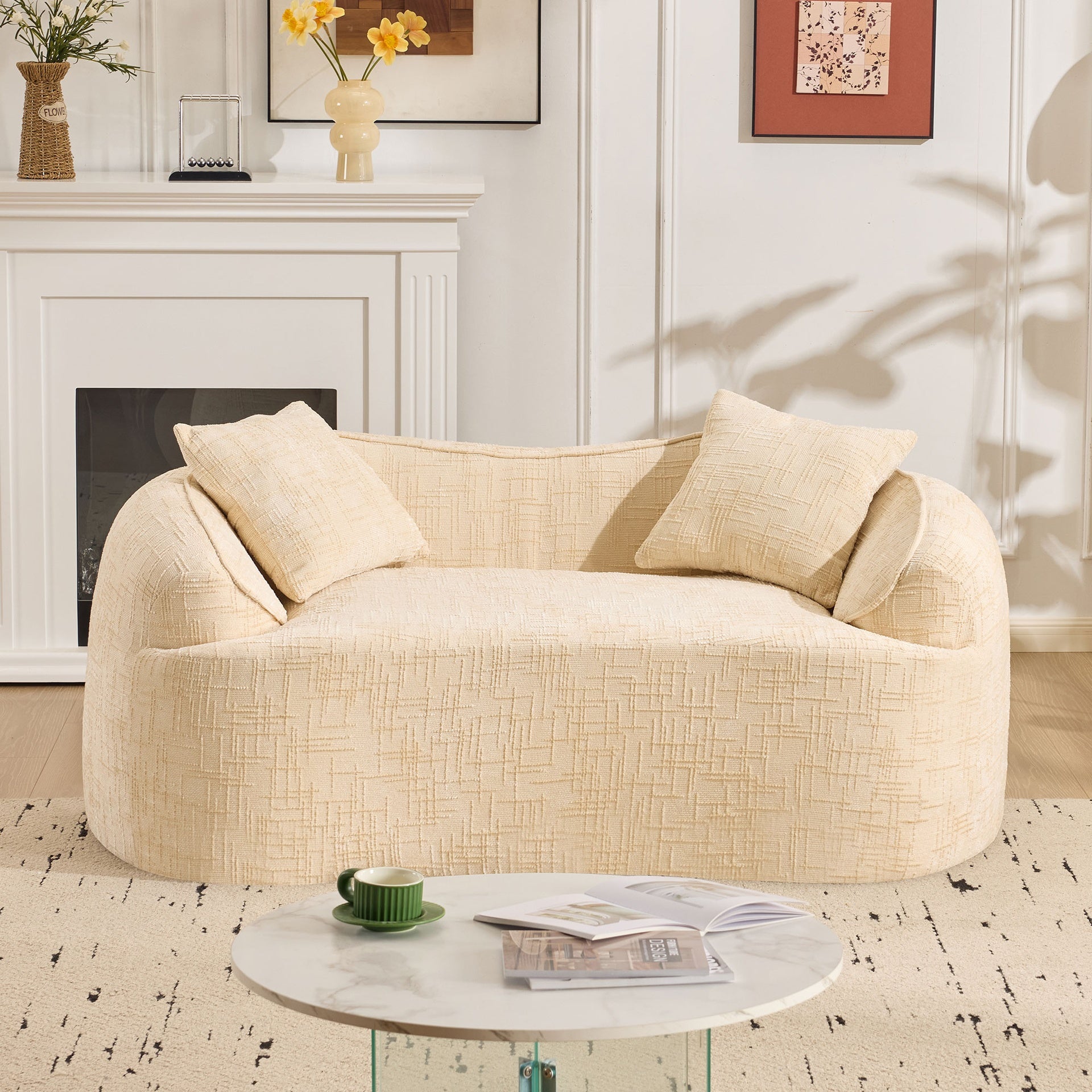 Beige curved two - person compress sofa. It has armrests on both sides, comes with two pillows, is suitable for small - sized apartments, and can be placed in the living room or bedroom.