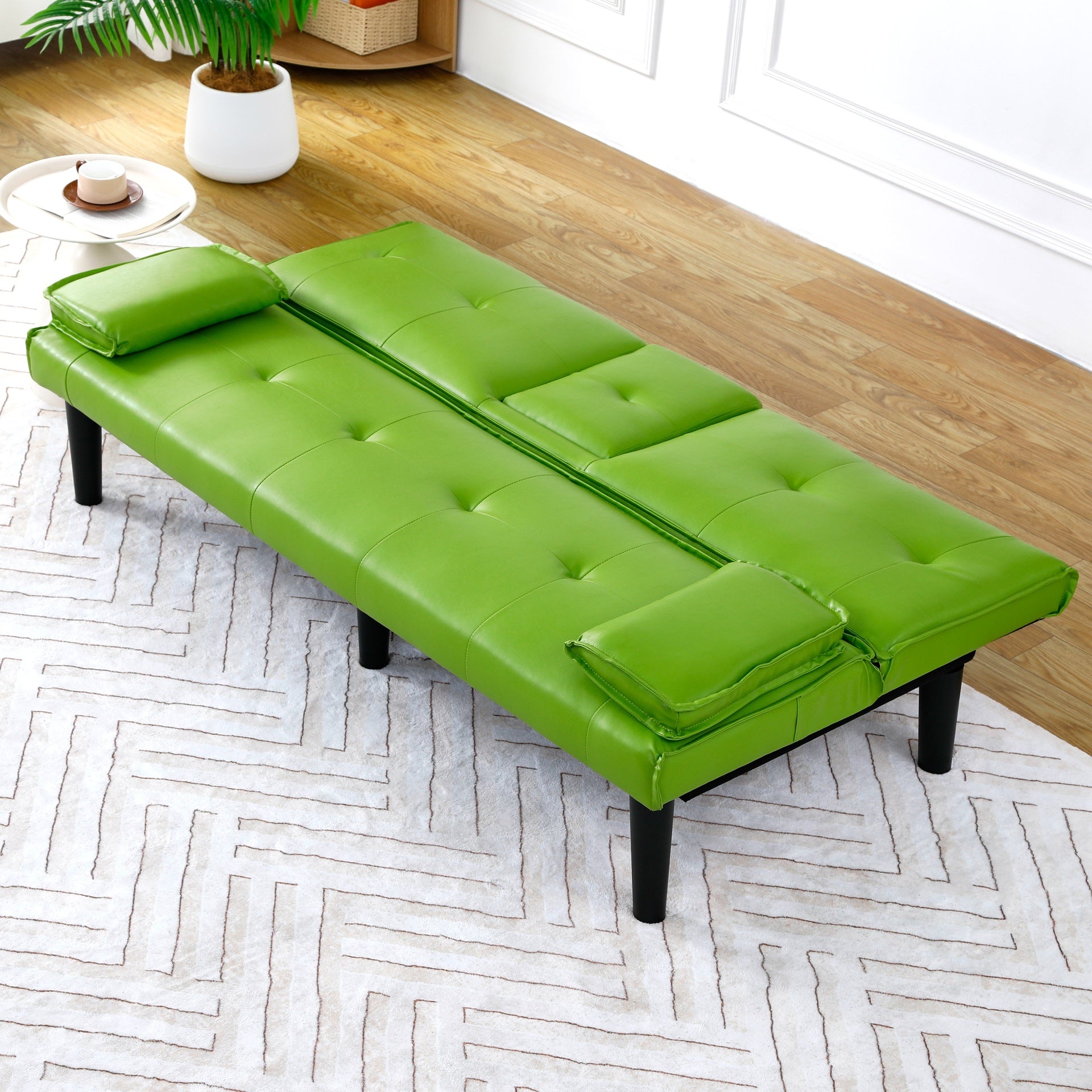 The 67-inch green PVC multi-functional sofa bed, with a foldable and cup holder design, makes it extremely convenient to turn the living room into a guest room