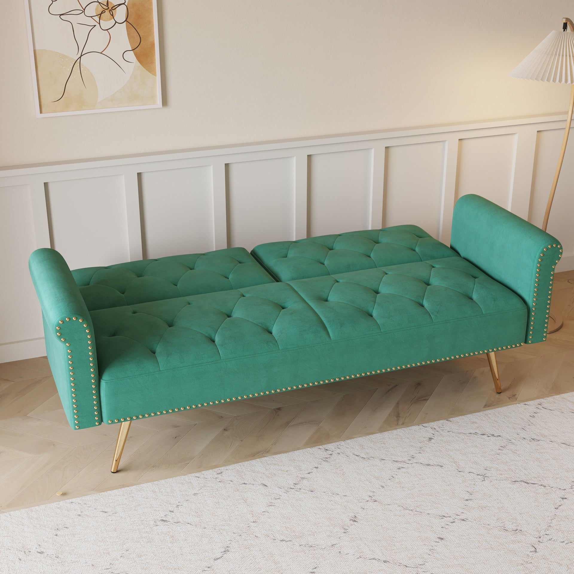 A 69.7-inch-long sofa bed covered in green velvet fabric, featuring nail head trim and accompanied by a matching throw pillow