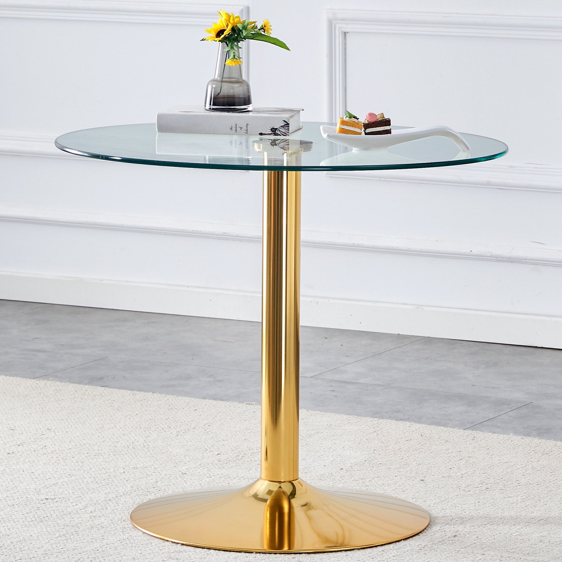 A 35-inch diameter glass top and a modern, minimalist round dining table with gold metal legs. Ideal for dining rooms, living rooms and meeting rooms.