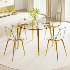 Table and chair set.Modern circular transparent tempered glass table, tempered glass tabletop, golden metal table legs.A Set of  4 Transparent Plastic Chairs with gold legs.