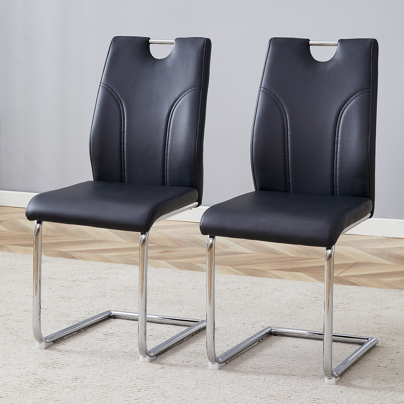 Black PU Dining Chair Set.Uniquely designed black dining chairs. PU material, paired with silver metal chair legs. Suitable for offices, restaurants, kitchens, conference rooms, etc.(Set of 2)