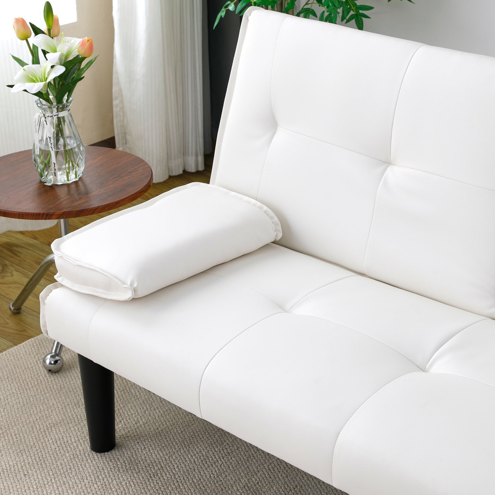 The 67-inch white PVC multi-functional sofa bed, with a foldable and cup holder design, makes it extremely convenient to turn the living room into a guest room