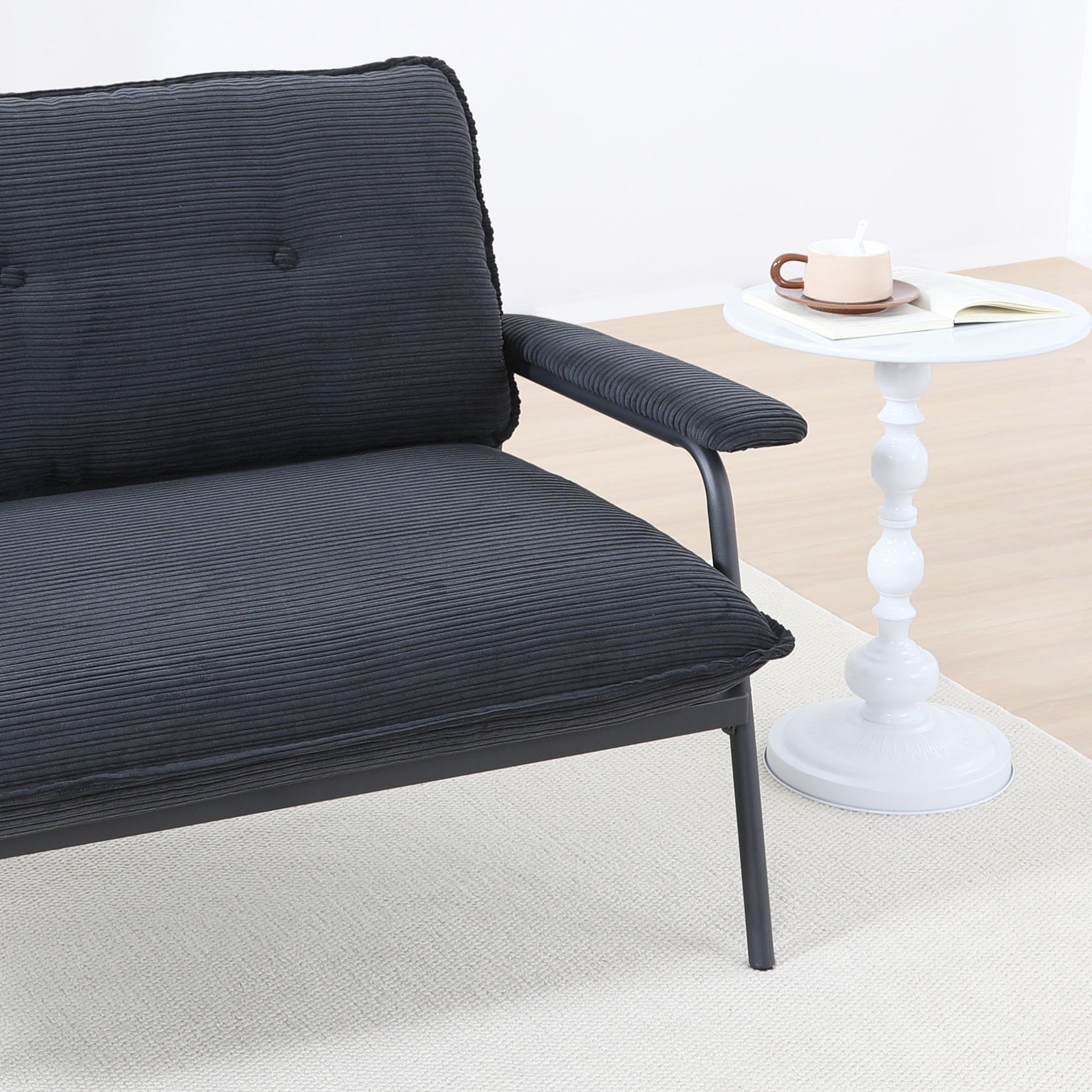 The 53-inch black sofa offers a spacious layout in the small apartment, easily handling various scenarios from watching movies to working