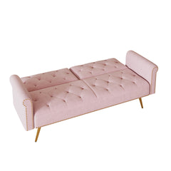 A 69.7-inch-long sofa bed covered in pink velvet fabric, featuring nail head trim and accompanied by a matching throw pillow