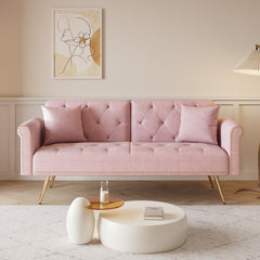 A 69.7-inch-long sofa bed covered in pink velvet fabric, featuring nail head trim and accompanied by a matching throw pillow