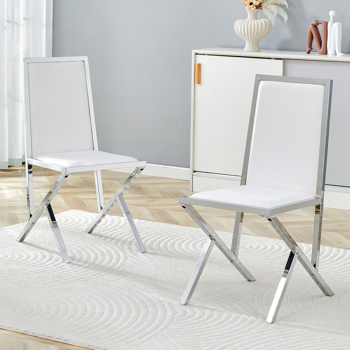2-pack silver metal framed white PU dining chairs: ergonomic design, a simple and luxurious choice.Featuring uniquely designed silver metal legs.