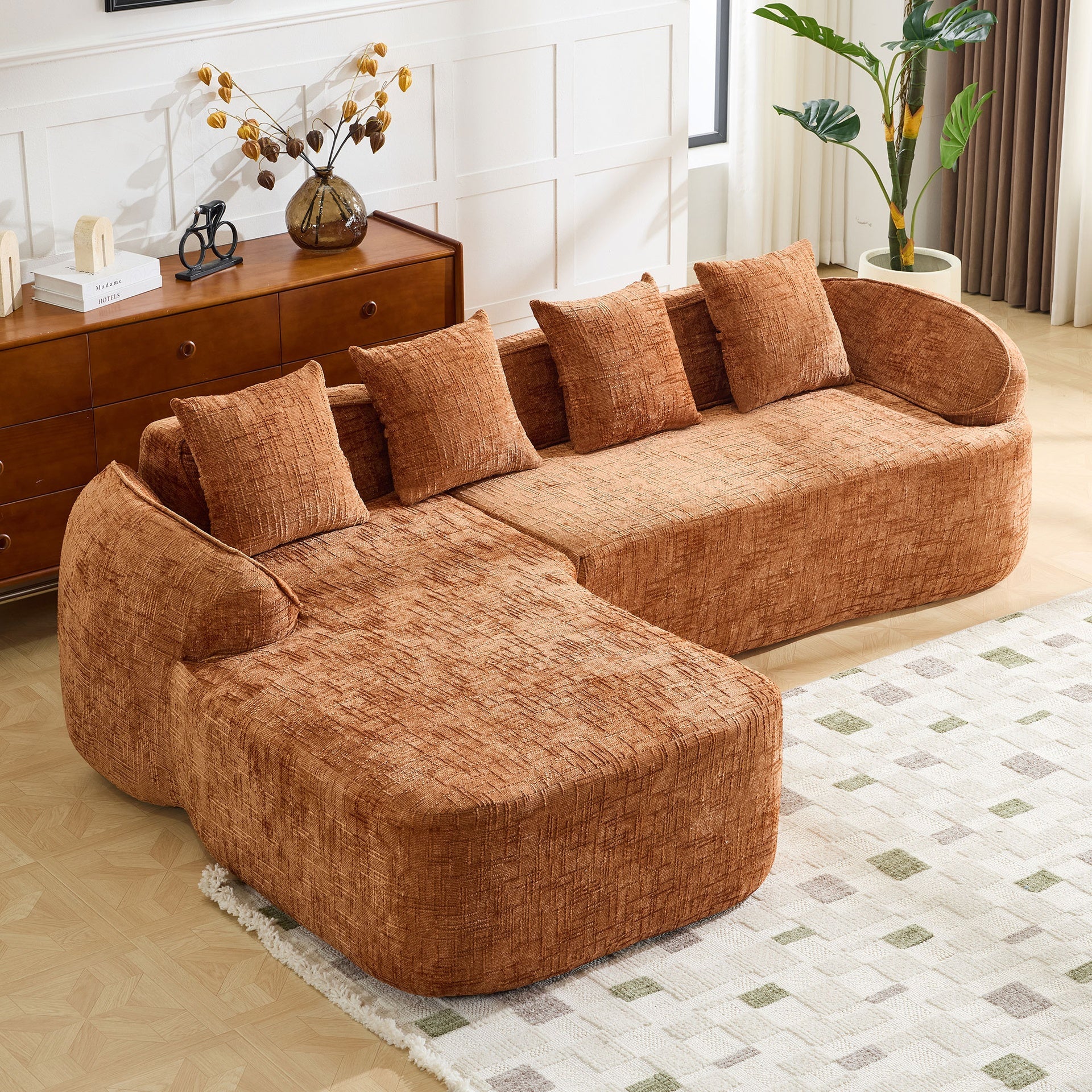 Orange chenille L-shaped compressed sofa that goes well with any living room. It features high-elastic sponge for a comfortable sitting feel,  curved armrests and four throw pillows.
