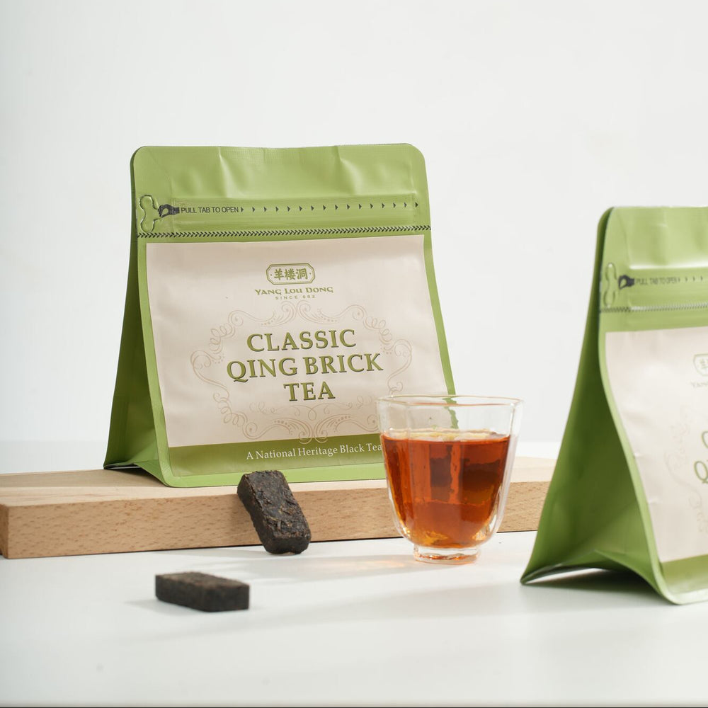 Green tea packaging with a glass of tea on a white background