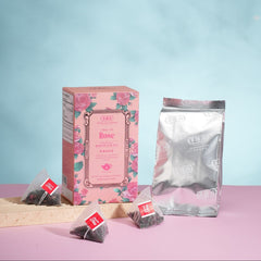 Tea packaging with a pink box and clear packaging on a light blue background