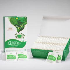 Green tea packaging with boxes and bags on a gray background