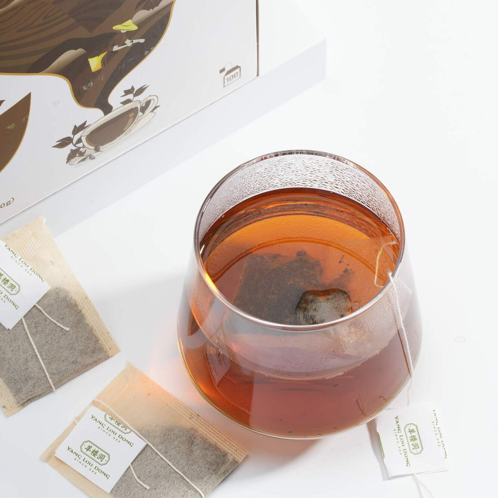 Tea packaging with a glass of tea and tea bags on a white background